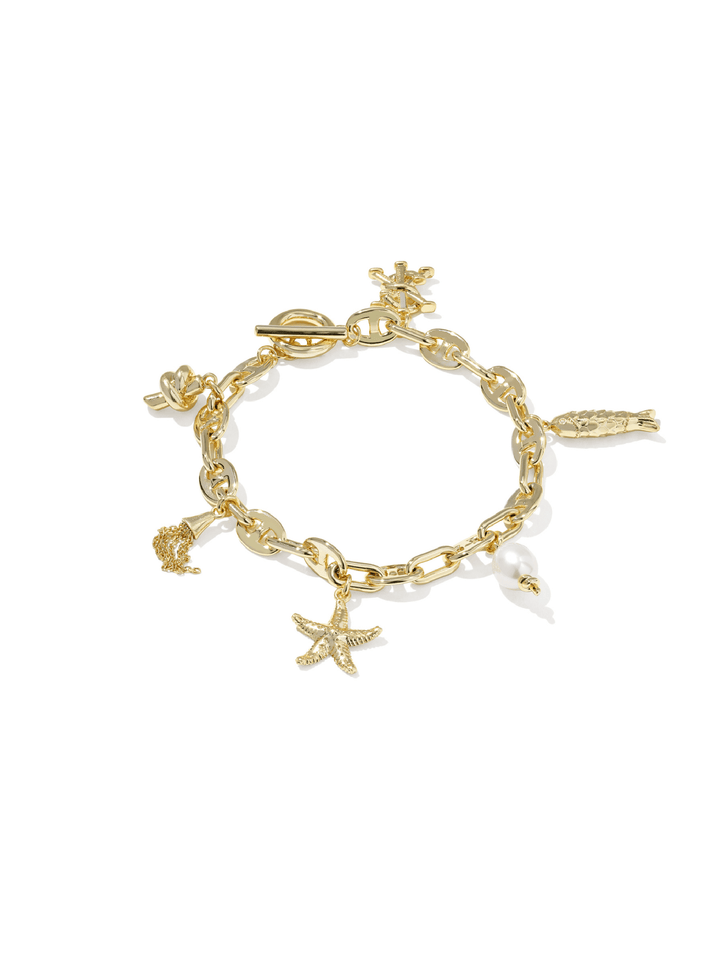 A gold-tone charm bracelet featuring a starfish, seashell, fish, and other small sea-themed charms, displayed on a clean white background.
