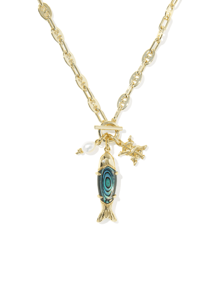 A gold-tone chain necklace featuring a fish-shaped abalone shell pendant with a blue-green iridescent pattern, a small white pearl charm, and a starfish charm, shown on a plain white background.