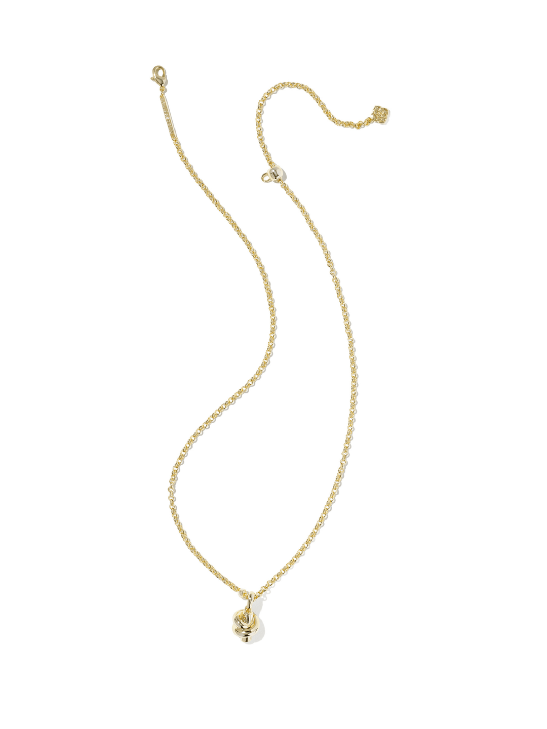 A delicate gold chain necklace with a small skull pendant, displayed on a clean white background.