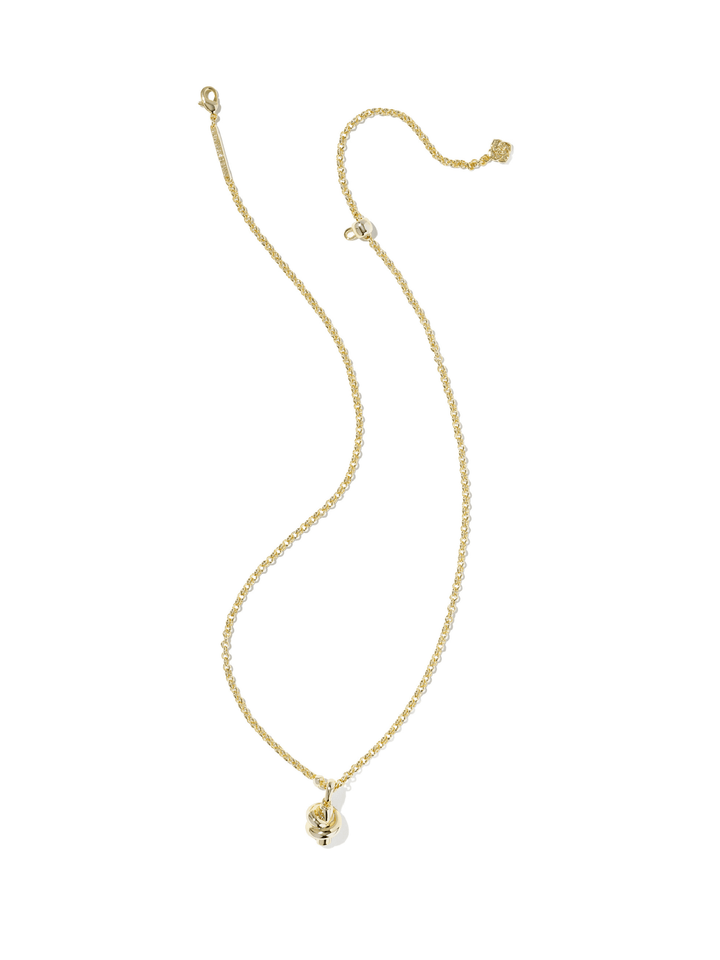 A delicate gold chain necklace with a small skull pendant, displayed on a clean white background.