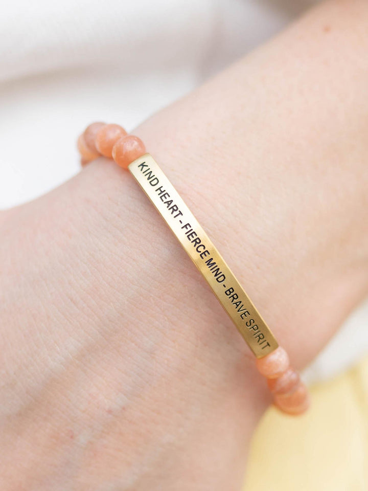 Warm Sunstone beaded bracelet with a gold bar engraved "KIND HEART - FIERCE MIND - BRAVE SPIRIT".