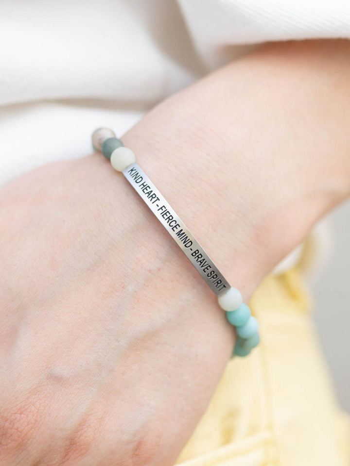 Amazonite stone bracelet with "Kind Heart, Fierce Mind, Brave Spirit" engraved on a silver bar.