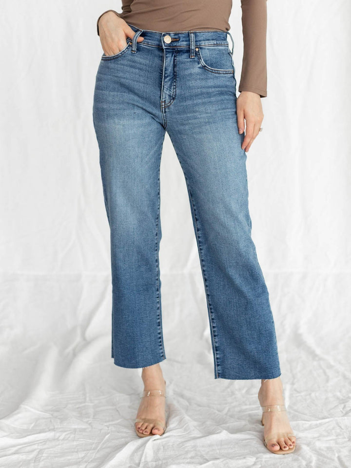 Person wearing blue jeans on a white background