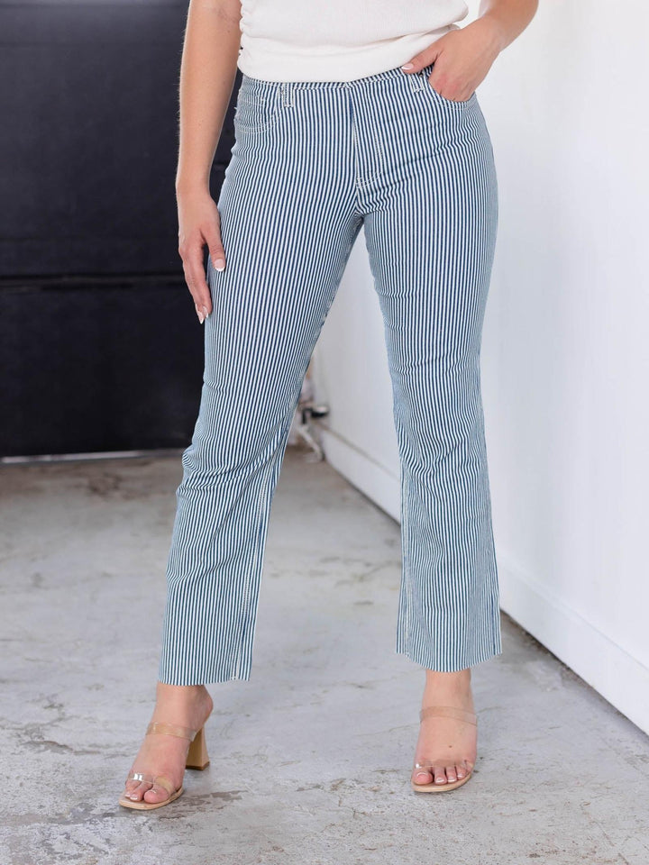 KUT Navy/Ivory Kelsey High Rise Fab Ab striped denim jeans on a model.