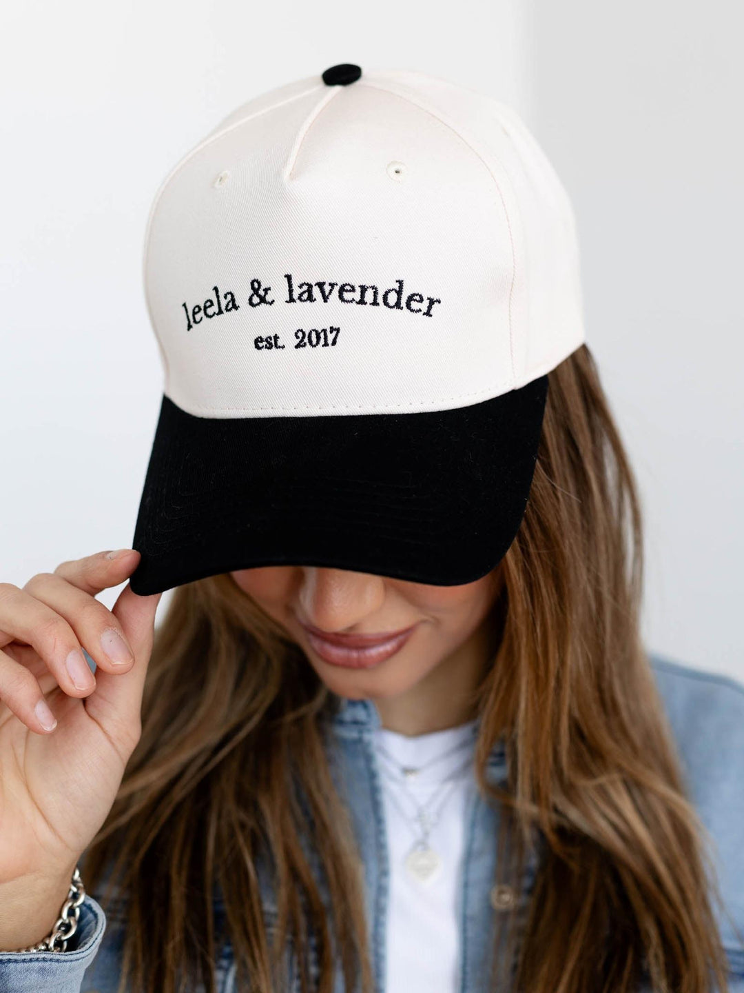 Person wearing a white and black cap with &
