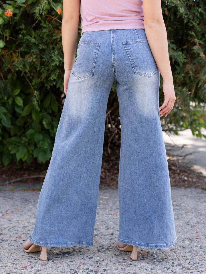 Light wash, high-waisted, wide-leg denim jeans with back pockets and front seam detailing.