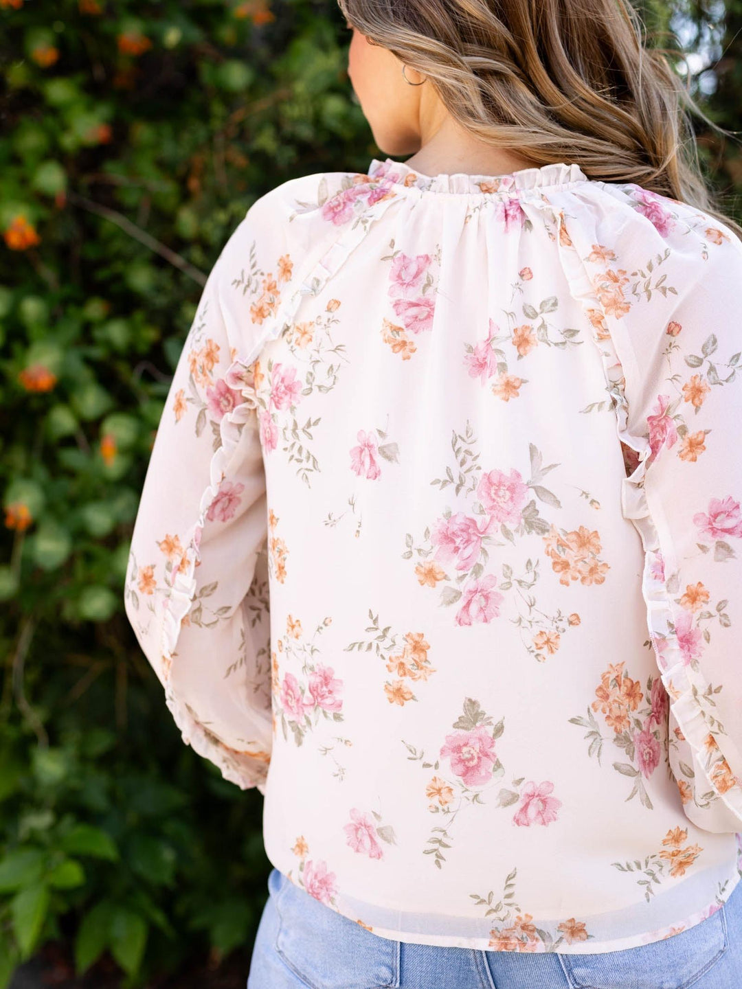 Lovestitch Natural/Dusty Rose floral ruffle button blouse with long sleeves, shown from the back.