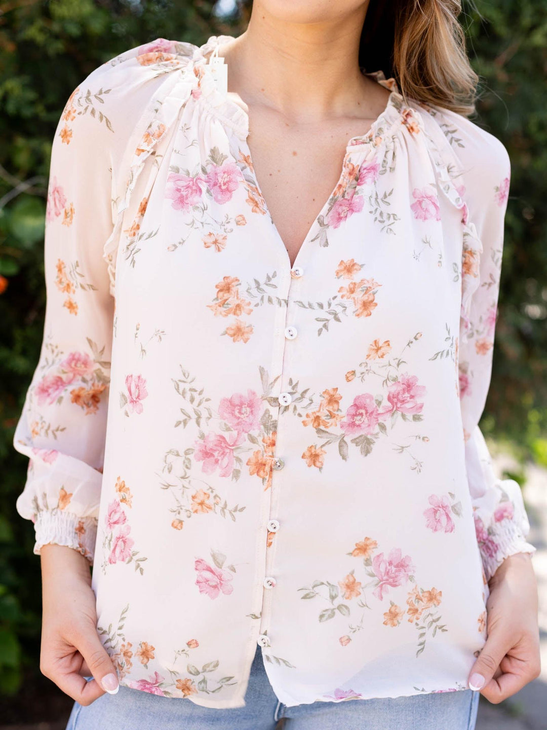 Lovestitch Natural/Dusty Rose floral ruffle button blouse with v-neck and long sleeves.