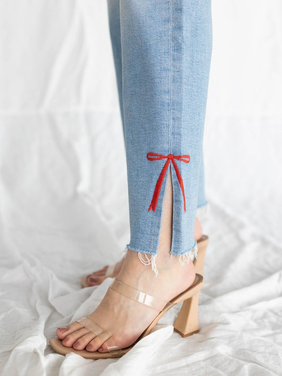 lightwash ankle denim with embroidered red bow