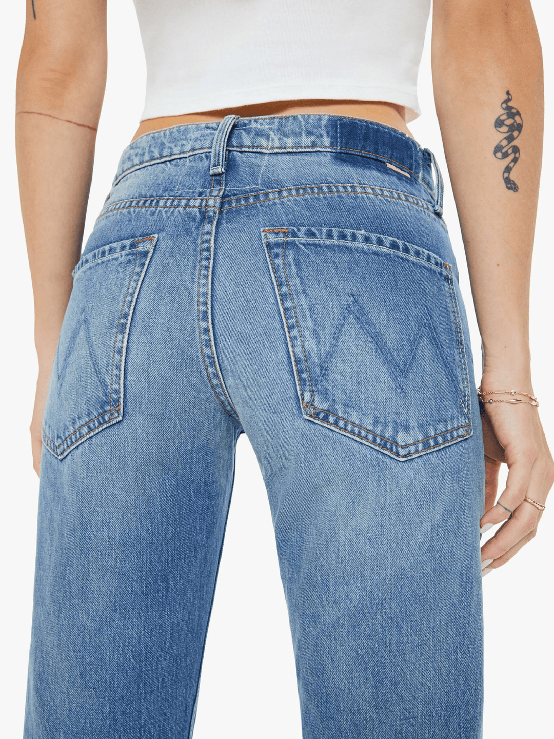 Blue jeans worn by a person on a white background