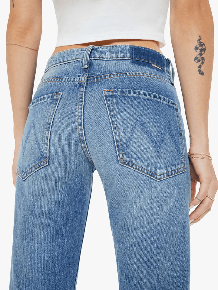 Blue jeans worn by a person on a white background