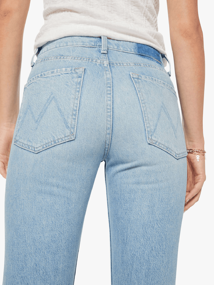 Light blue jeans worn by a person on a white background