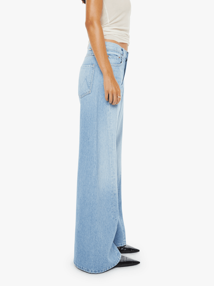 Light blue wide-leg jeans worn by a person on a white background