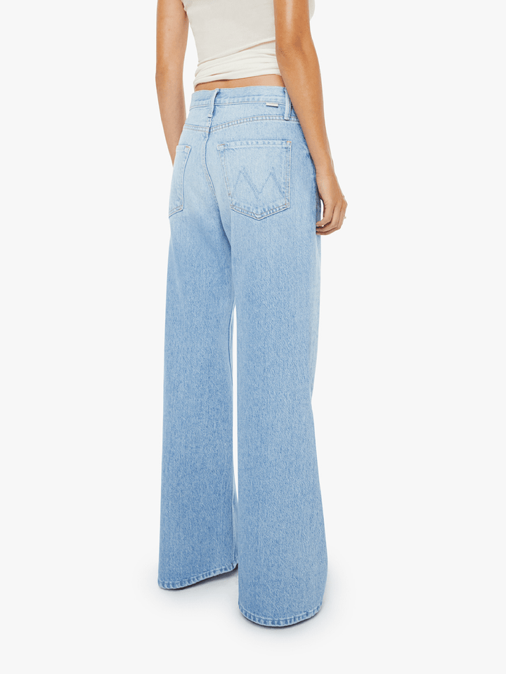 Light blue jeans worn by a person on a white background