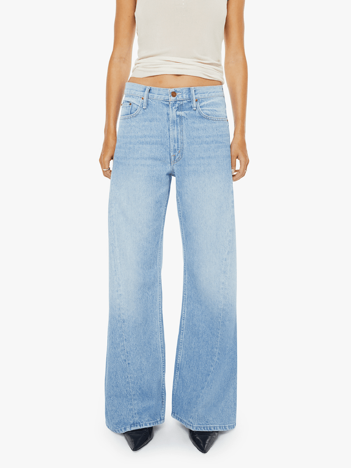Light blue jeans worn by a person on a white background