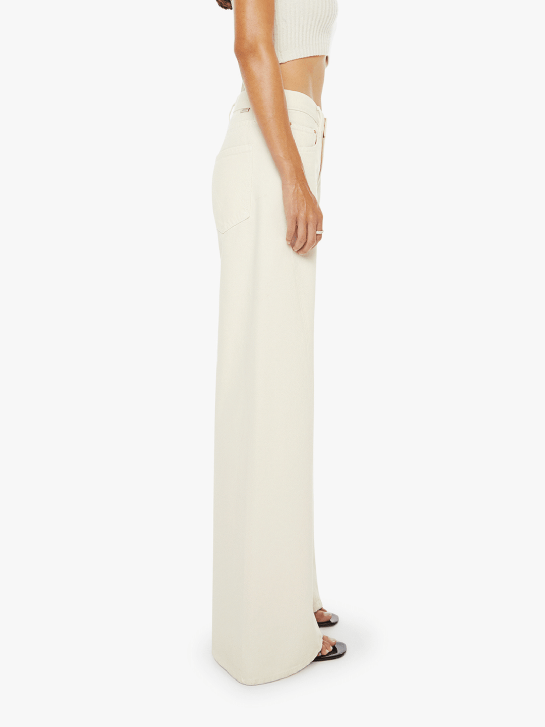 Person wearing white wide-leg pants on a white background