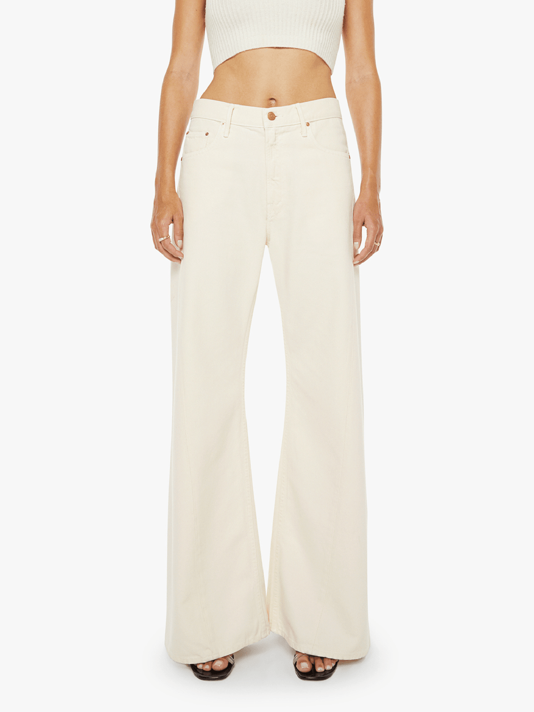 Person wearing cream-colored wide-leg pants on a white background
