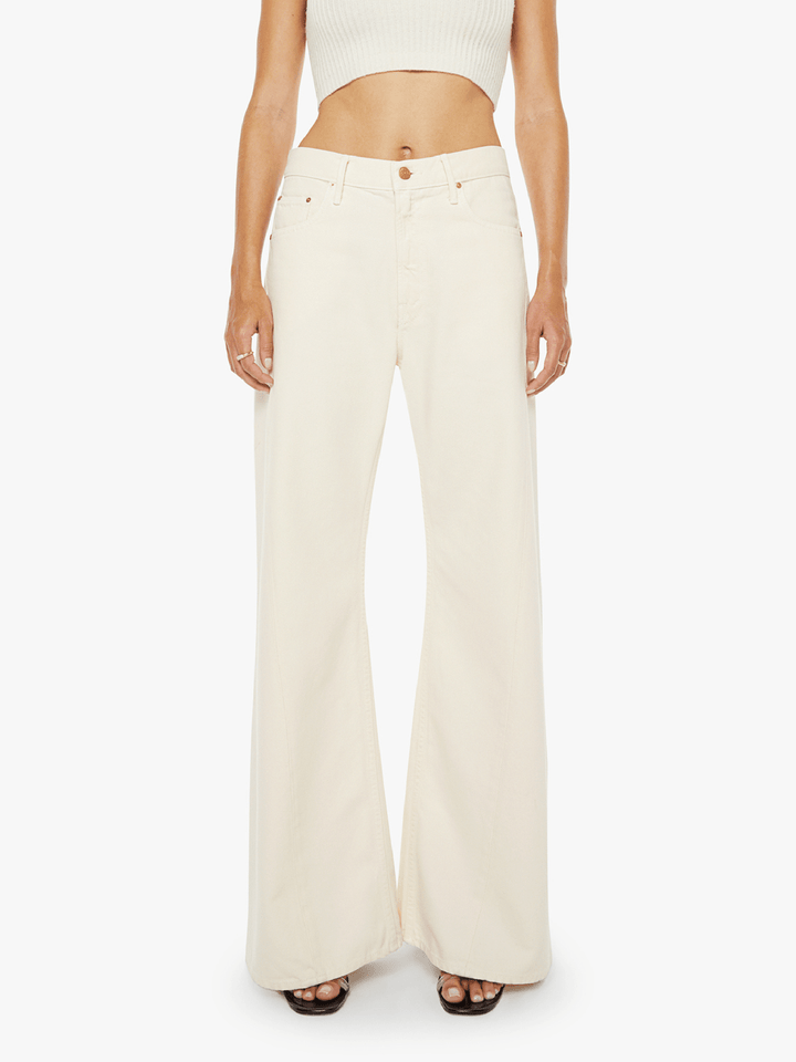 Person wearing cream-colored wide-leg pants on a white background