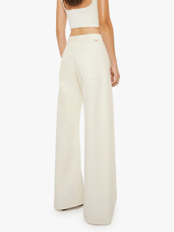 Person wearing a white top and wide-leg pants on a white background