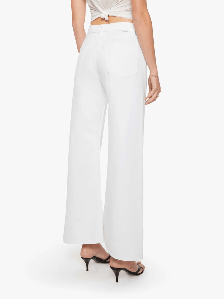 White wide-leg cropped pants shown from the back on a model, paired with a cream tied crop top and black high-heeled sandals, against a light gray studio background.