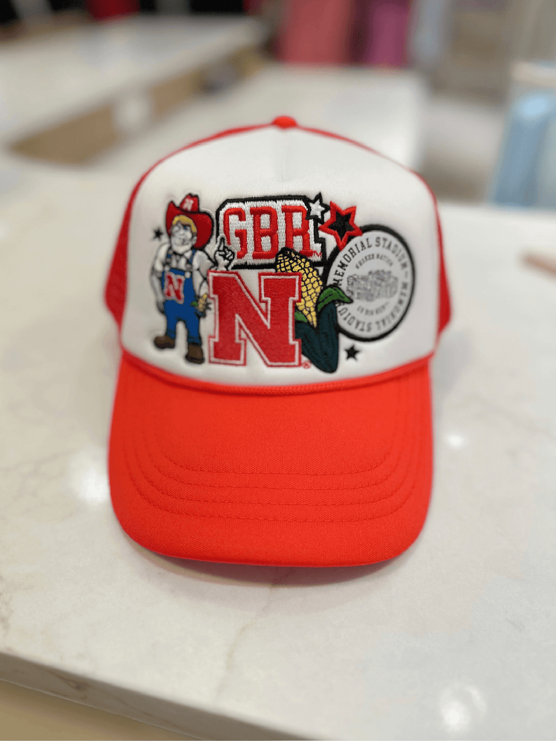 Red and white cap with graphics and text on a light surface