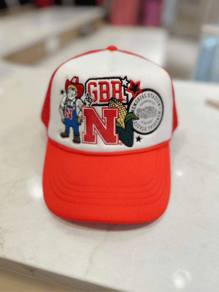Red and white cap with graphics and text on a light surface