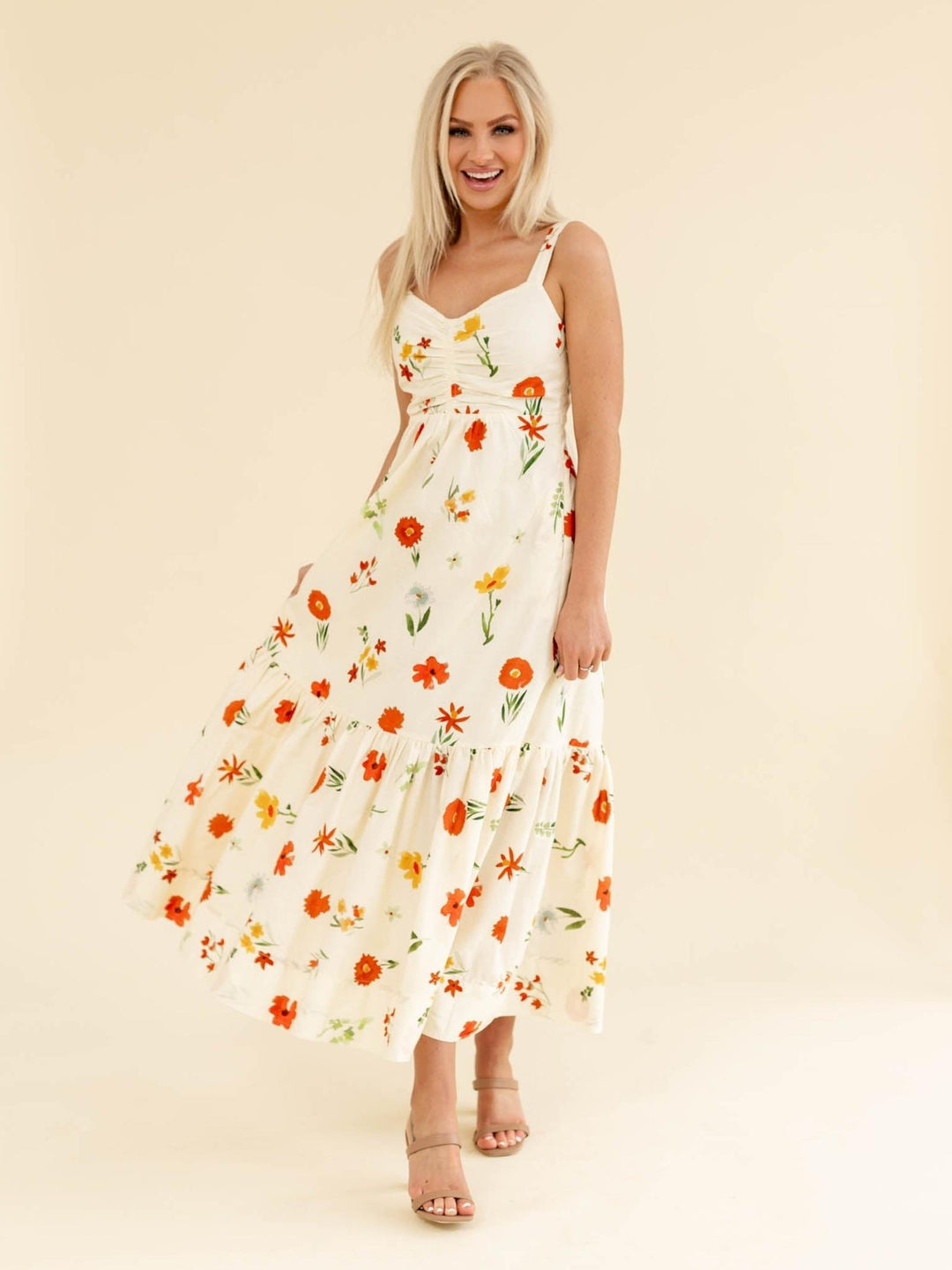 Woman wearing a floral dress on a beige background