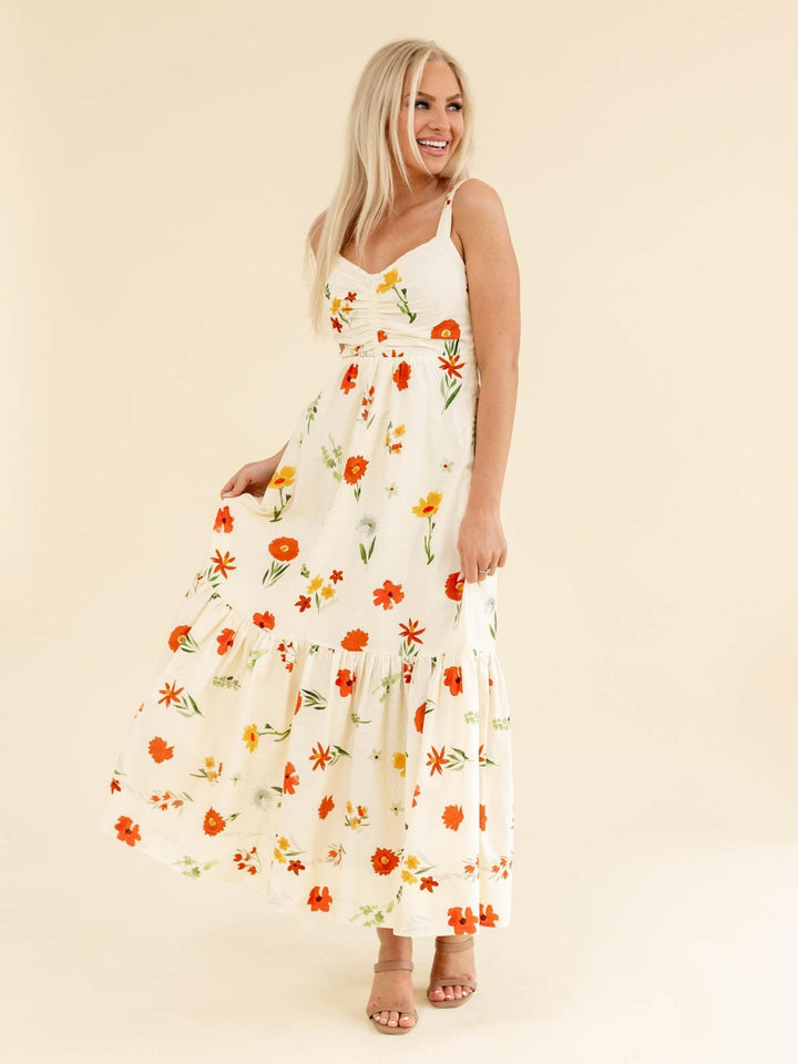 Woman wearing a floral dress on a beige background