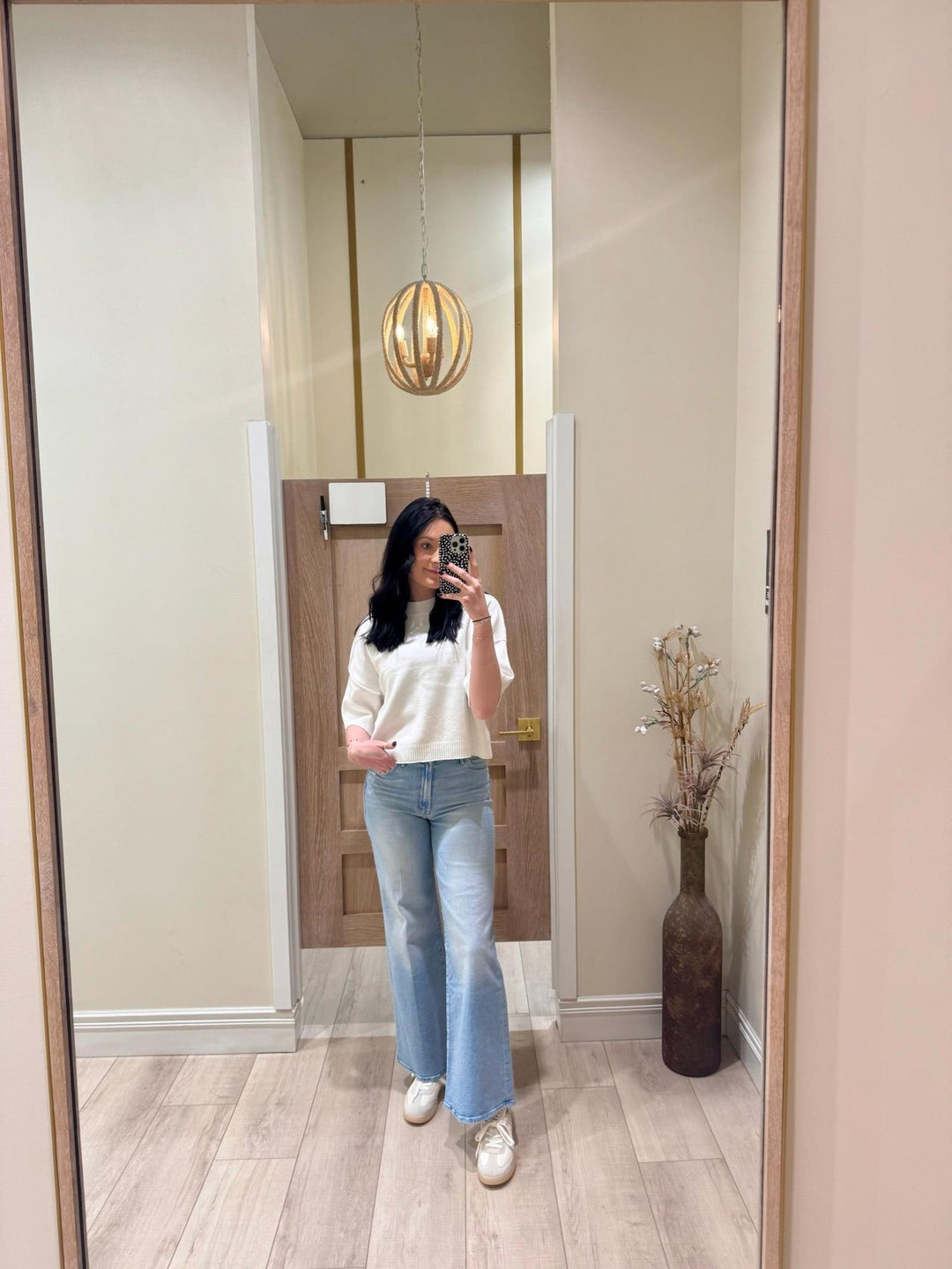 Woman in a white PINCH Short Sleeve Sweater Top with 3/4 sleeves, exposed seams, and rolled hemlines.