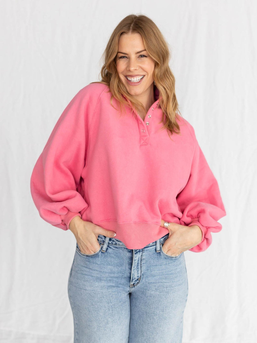 pink half button pullover with puff sleeves