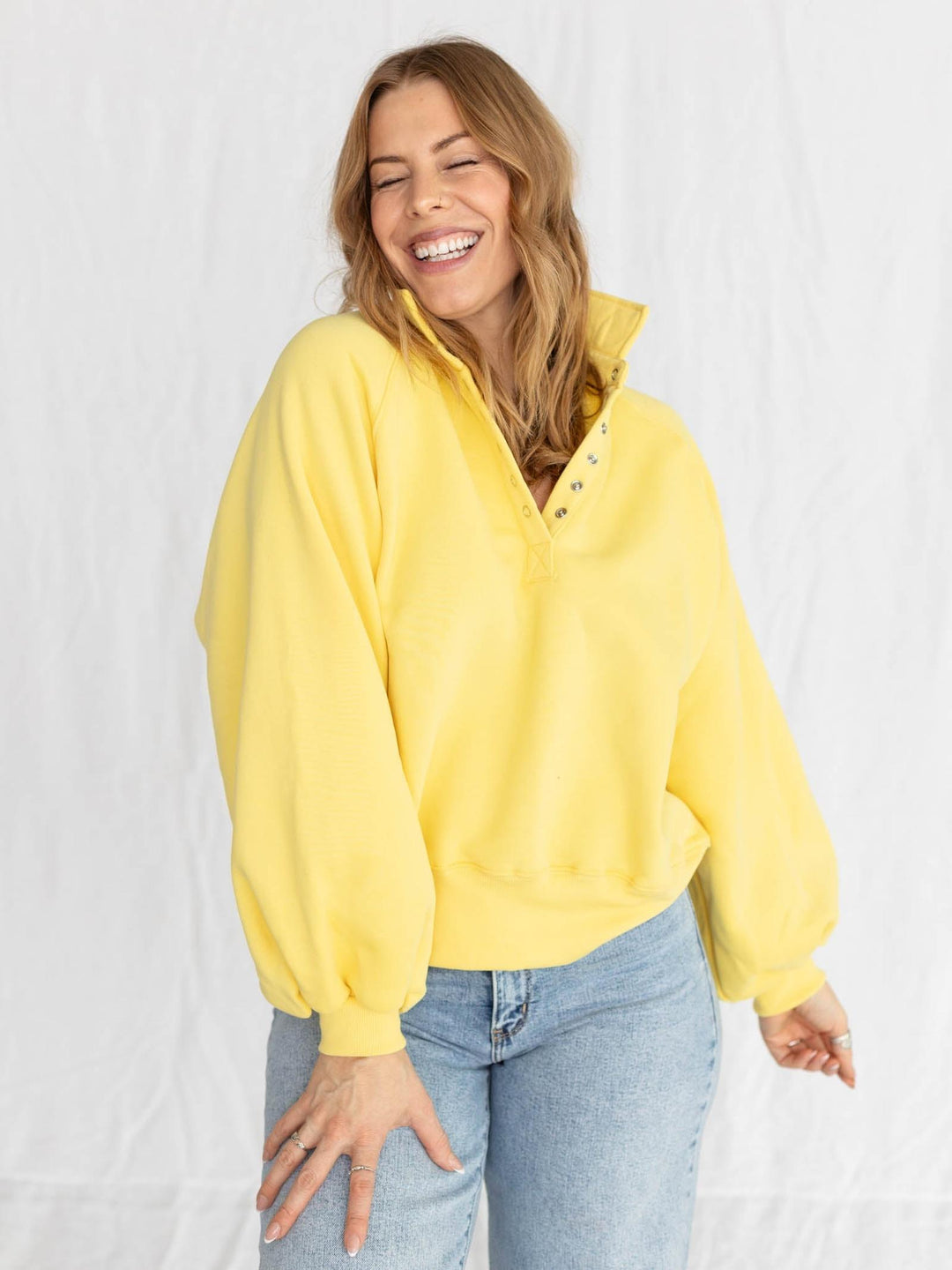 yellow half button pullover with puff sleeves