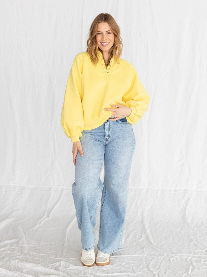 yellow half button pullover with puff sleeves