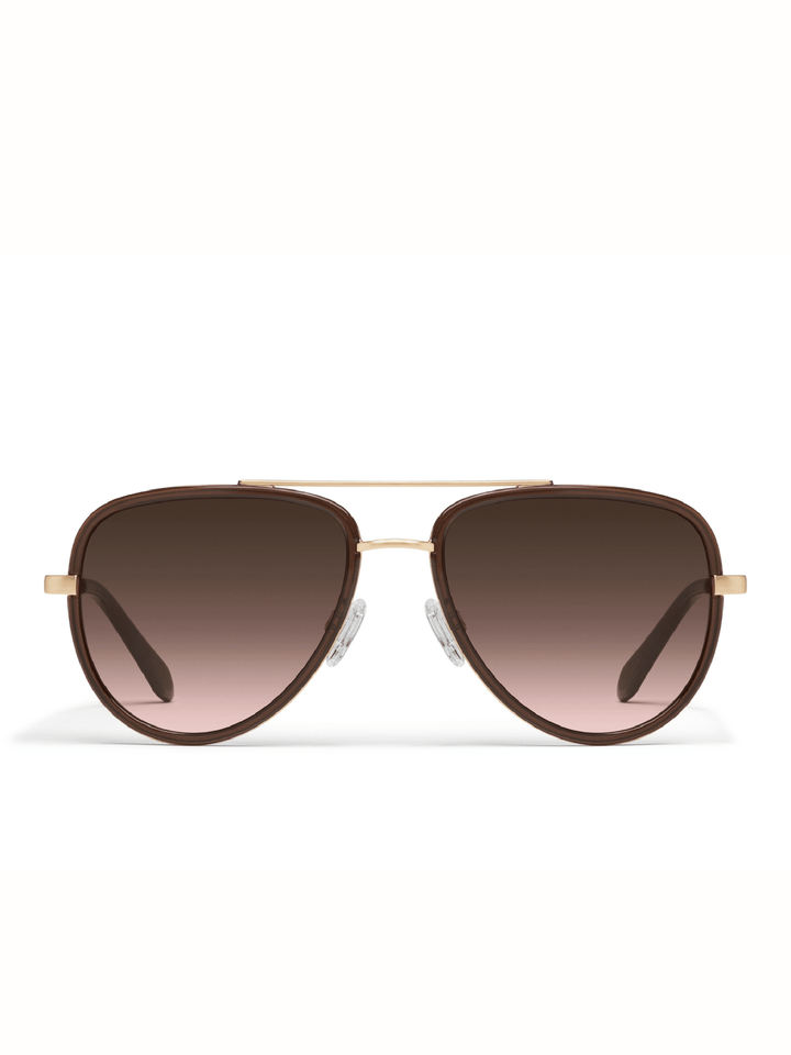 A pair of aviator sunglasses with a brown gradient lens, gold metal frame, and gold double bridge, shown against a plain white background.