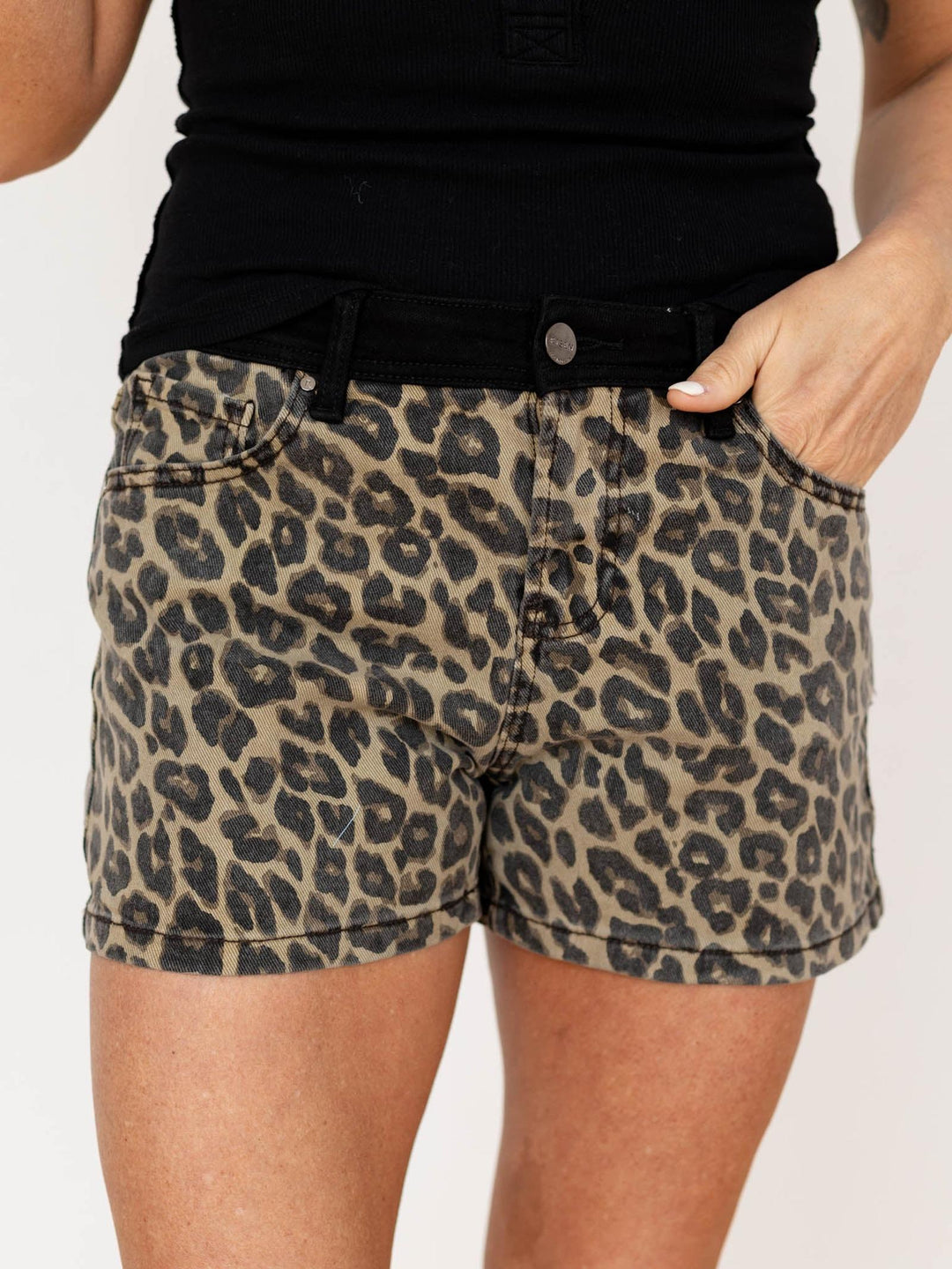 Leopard print shorts worn by a person on a plain background