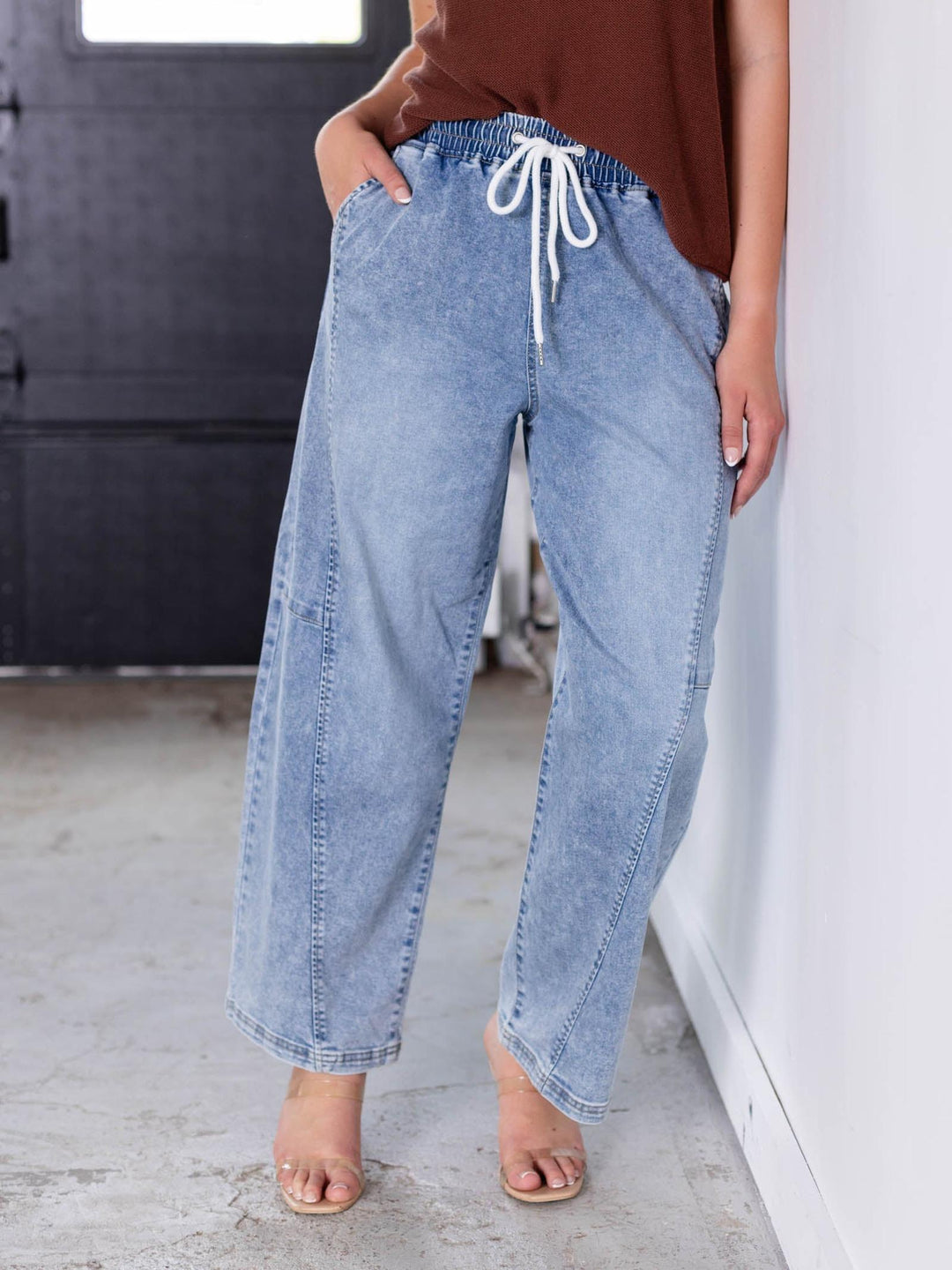 Light wash Risen slouchy crop barrel jeans with seam detail and white drawstring waist.