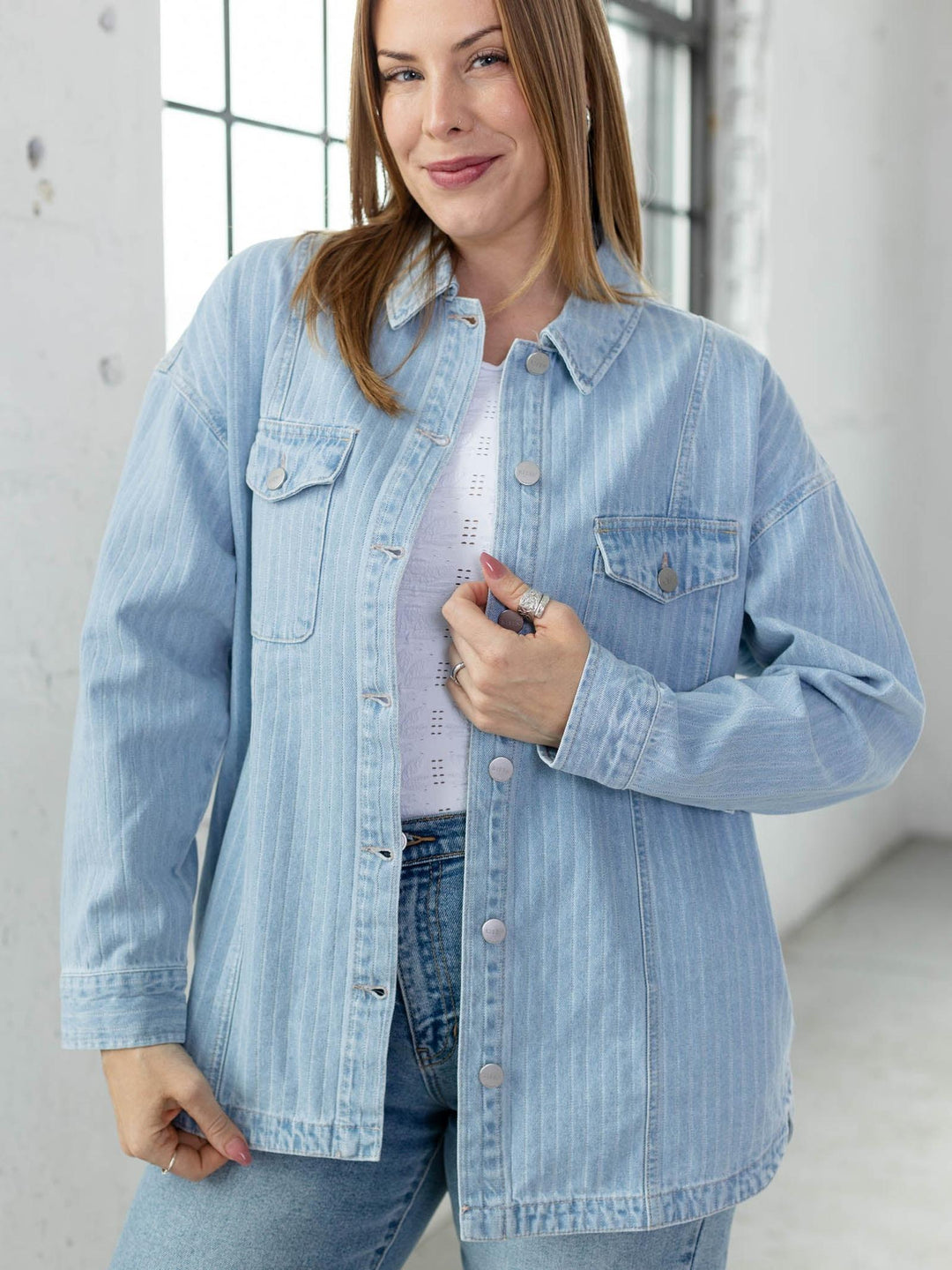Woman wearing a light blue denim jacket indoors