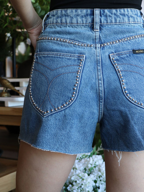 studded medium wash cut off shorts