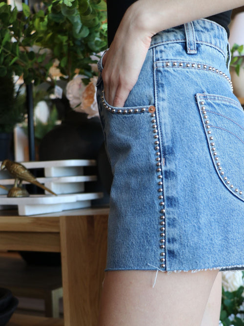 studded medium wash cut off shorts