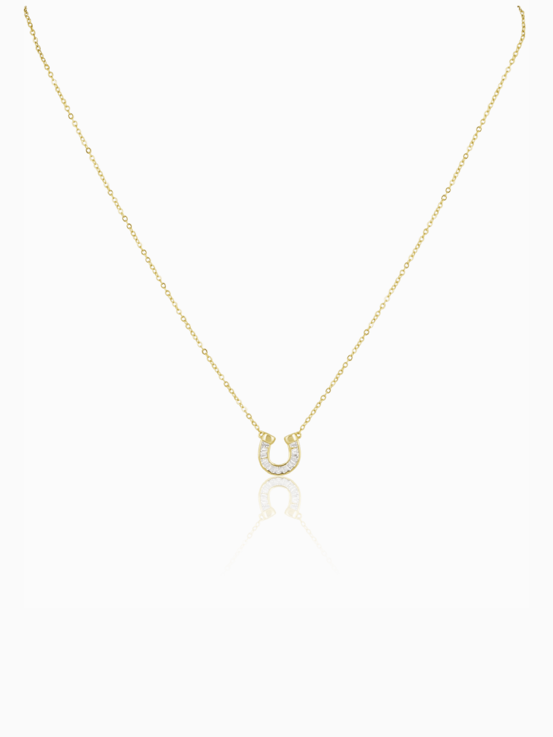 Gold necklace with a small pendant on a white background