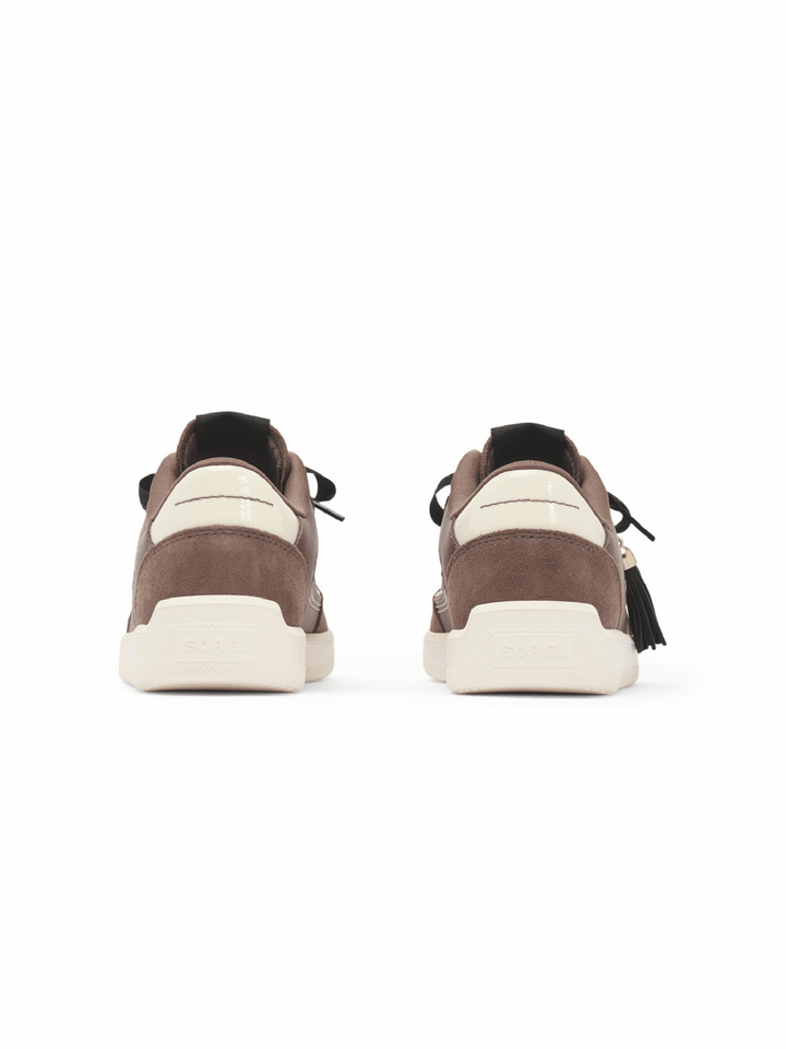 A pair of brown suede sneakers shown from the back, featuring cream-colored midsoles and black laces, set against a plain white background.