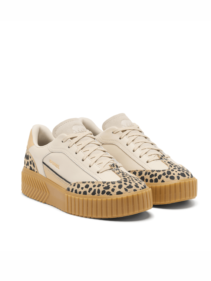 Beige sneakers with leopard print pattern and brown soles on a white background
