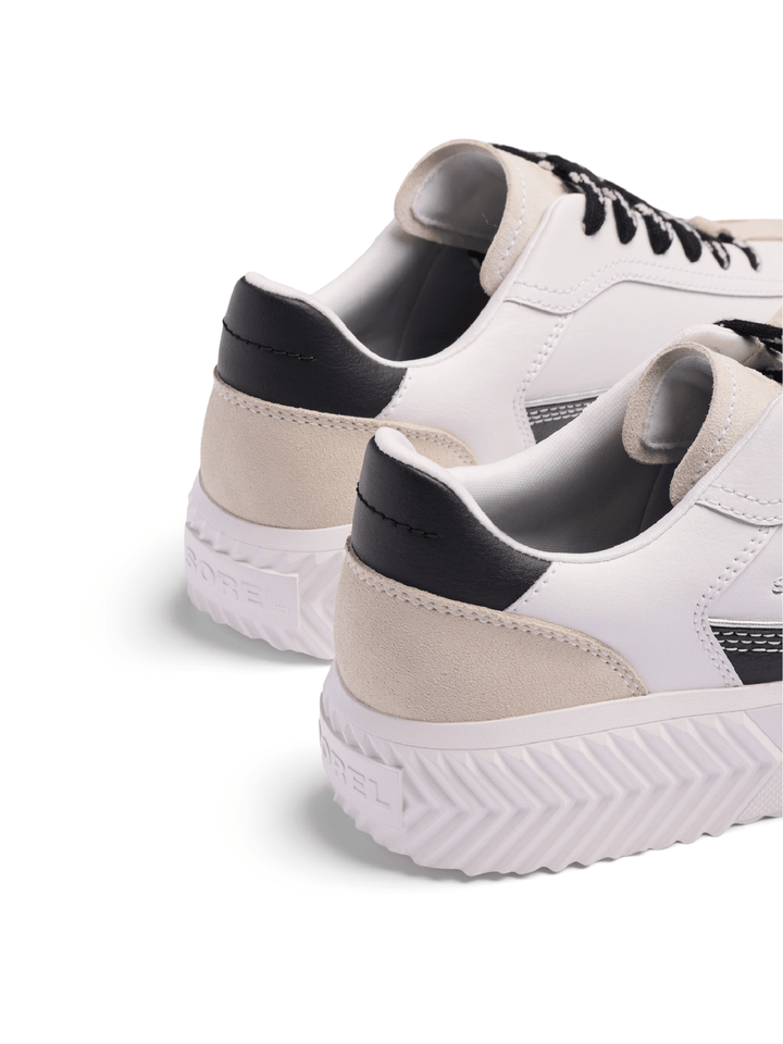 White sneakers with black accents on a white background