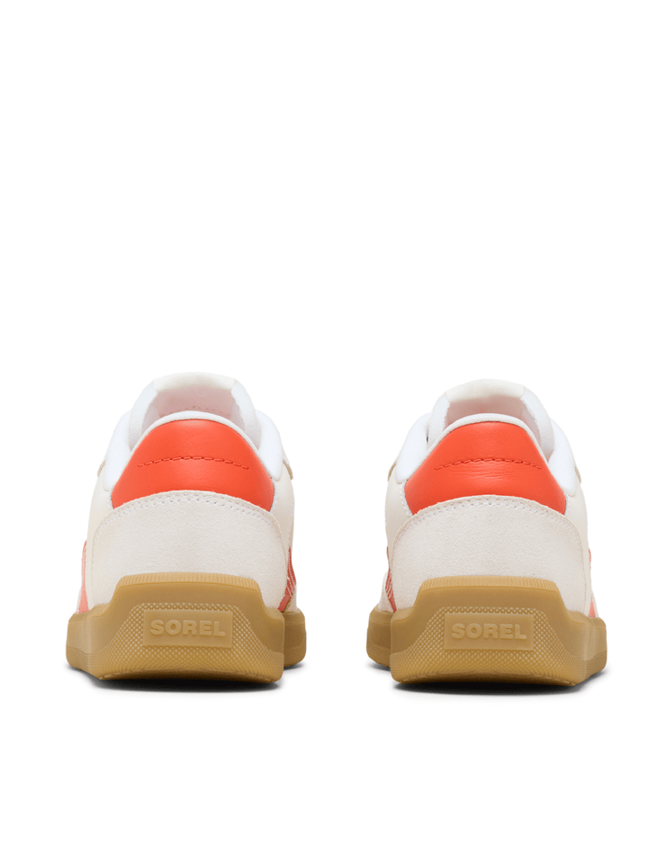 White sneakers with orange accents and brown soles on a white background