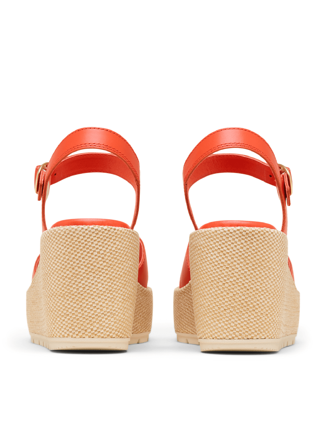 Red sandals with woven soles on a white background
