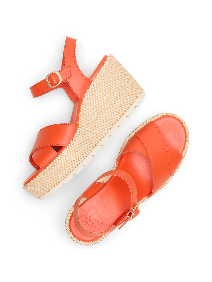 Orange sandals with a woven sole on a white background