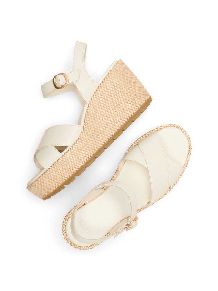 Pair of beige sandals with a woven design on a white background