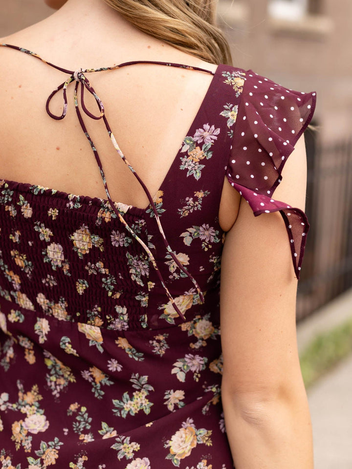Steve Madden Tanisha Dress in Port with floral and polka dot patterns, flutter sleeves, and ruched back tie.