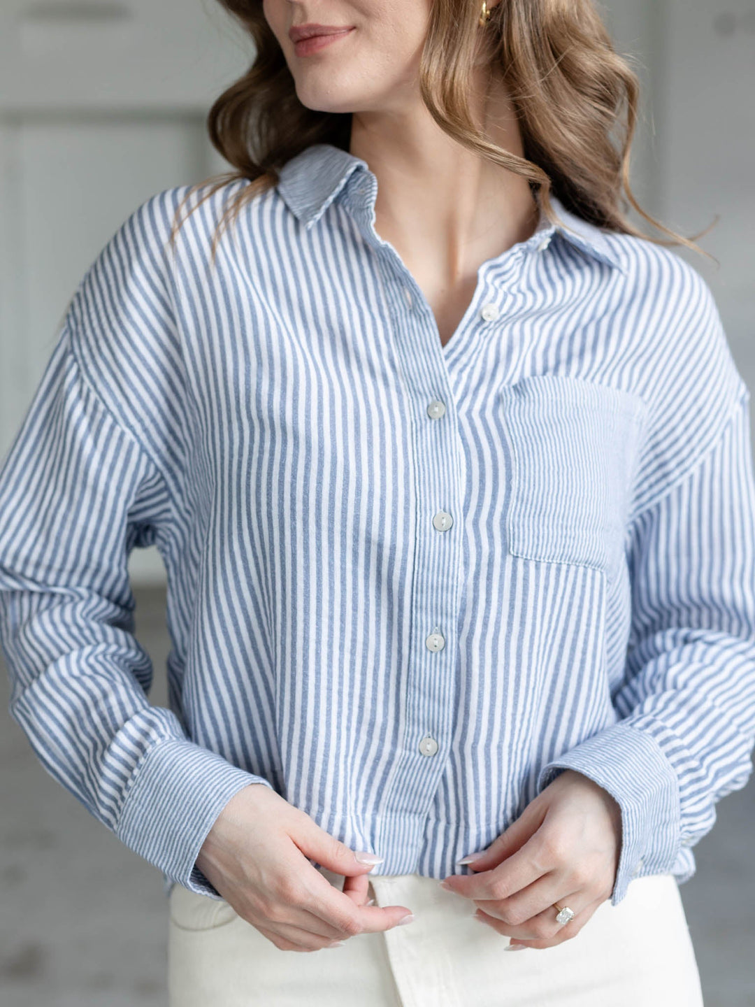 white and blue cropped long sleeve blouse