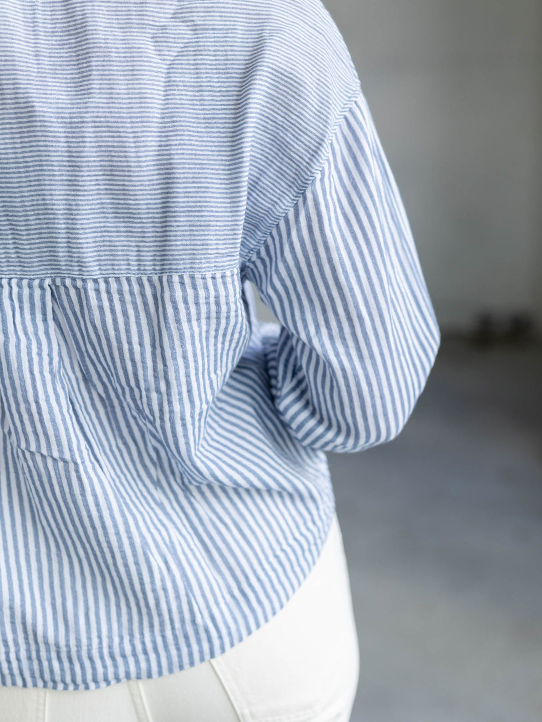 white and blue cropped long sleeve blouse