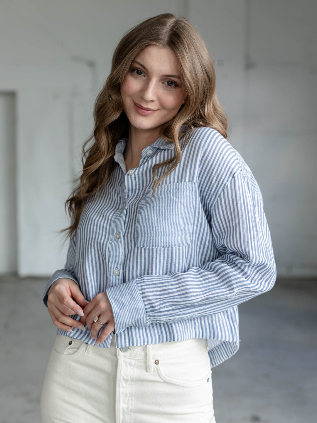 white and blue cropped long sleeve blouse